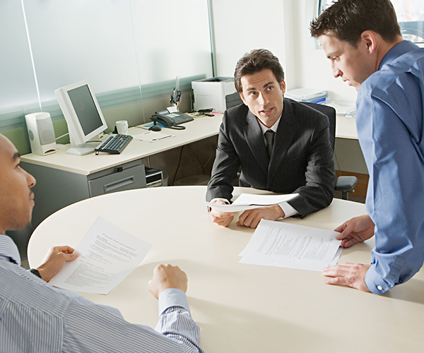 Businessmen discussing document